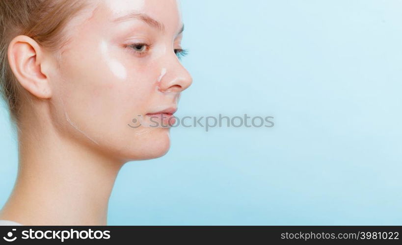 Young woman in facial peel off mask. Peeling. Beauty and skin care. Side view. woman in facial peel off mask.