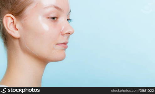 Young woman in facial peel off mask. Peeling. Beauty and skin care. Side view. woman in facial peel off mask.