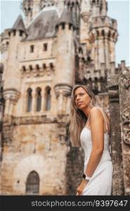 Young woman in front of the Butron Castle in Vizcaya, Spain