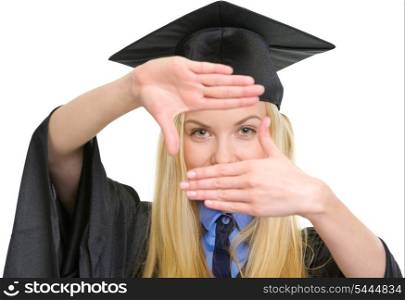 Young woman in graduation gown framing with hands
