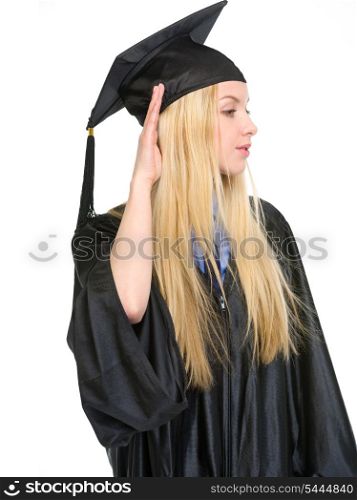 Young woman in graduation gown listening