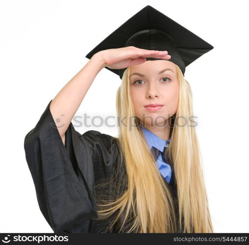 Young woman in graduation gown looking into distance