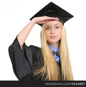 Young woman in graduation gown looking into distance