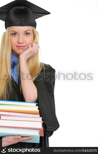 Young woman in graduation gown with stack of books