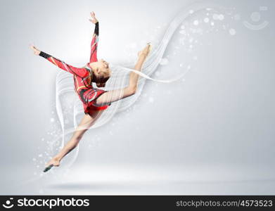 Young woman in gymnast suit posing. Young cute woman in gymnast suit show athletic skill on white background