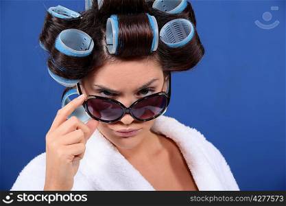 Young woman in hair rollers and sunglasses