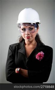 Young woman in hard hat and safety goggles