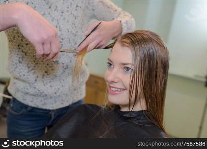 young woman in her hair studio with customer