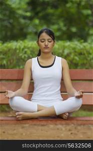 Young woman in lotus position meditating