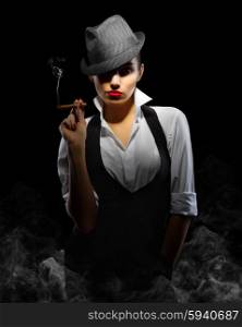 Young woman in manly style with cigar on smoky background