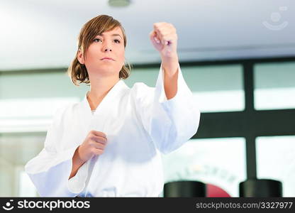 Young woman in martial art training in a gym