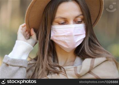 young woman in medical protective mask outdoors. Air pollution, environmental concept isolated. selective focus.. young woman in medical protective mask outdoors. Air pollution, environmental concept isolated. selective focus