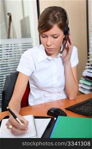 Young woman in office with headset