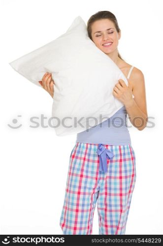 Young woman in pajamas enjoying cosy pillow