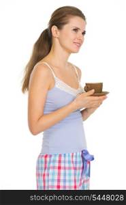 Young woman in pajamas with cup of coffee