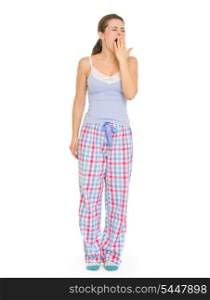 Young woman in pajamas yawing