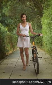 Young woman in park with bicycle