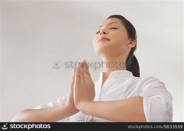 Young woman in prayer position