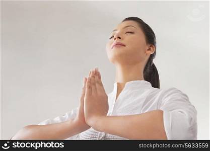 Young woman in prayer position