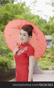 Young Woman in Qipao with Umbrella