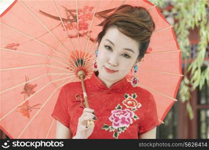 Young Woman in Qipao with Umbrella