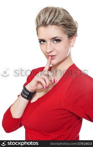 Young woman in red dress gesturing silence over white