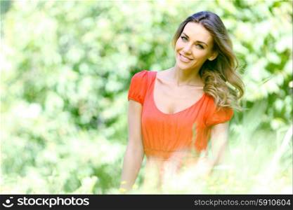 young woman in red dress sitting on grass