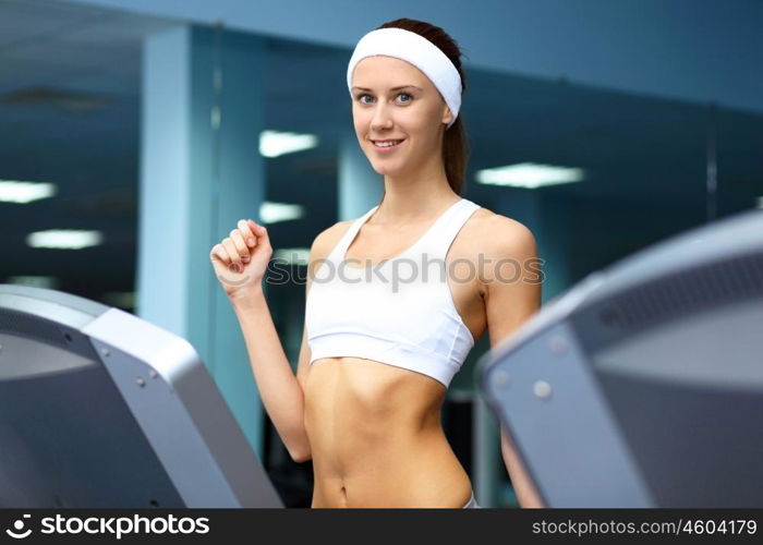 Young woman in sport wear doing sport in gym