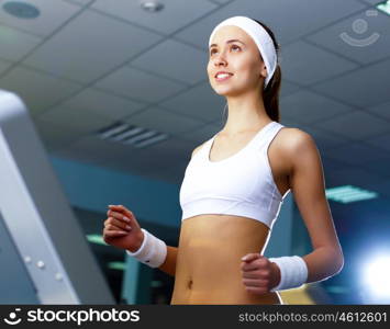 Young woman in sport wear doing sport in gym