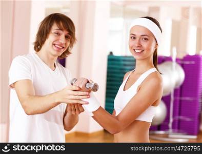 Young woman in sport wear doing sport in gym