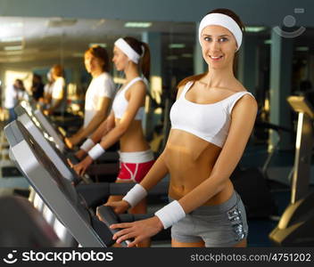 Young woman in sport wear doing sport in gym