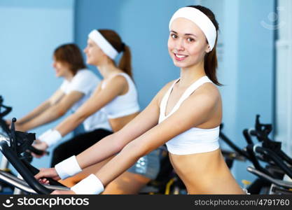 Young woman in sport wear doing sport in gym