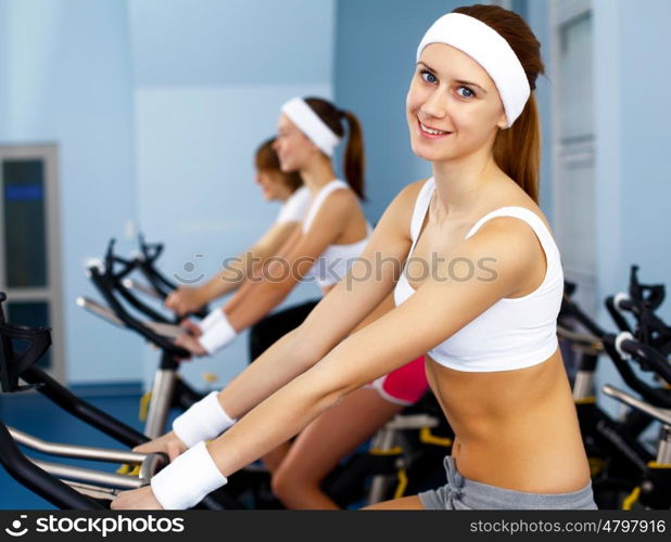 Young woman in sport wear doing sport in gym