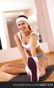 Young woman in sport wear doing sport in gym