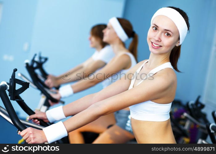 Young woman in sport wear doing sport in gym