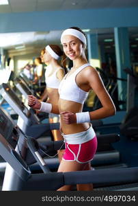 Young woman in sport wear doing sport in gym