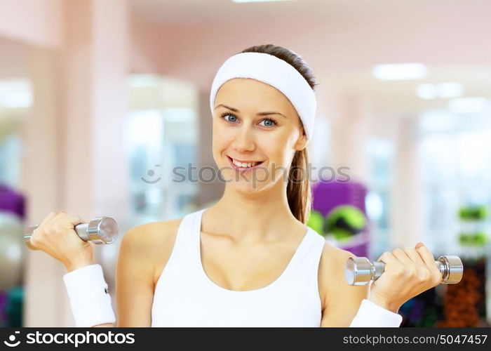 Young woman in sport wear doing sport in gym