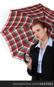 Young woman in suit with an umbrella