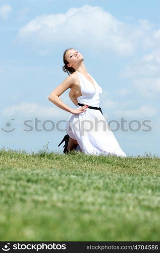 Young woman in summer dress on a background of the blue sky