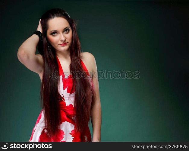 young woman in summer flowery dress on green background fashion photo