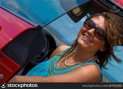 Young woman in sunglasses with luxury car