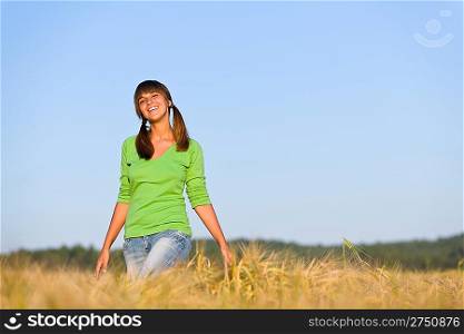Young woman in sunset corn field enjoy sun