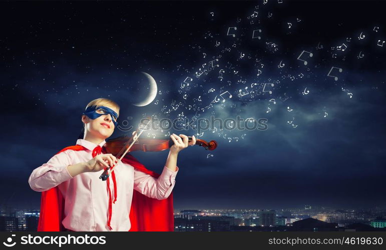 Young woman in super hero costume playing violin. She is super woman