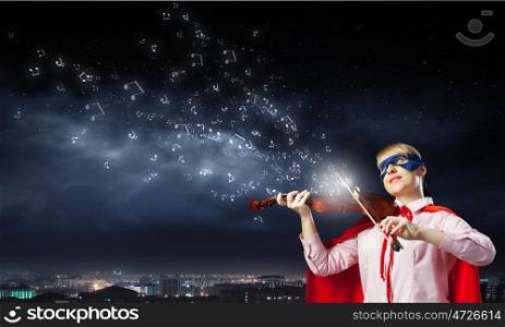 Young woman in super hero costume playing violin. She is super woman