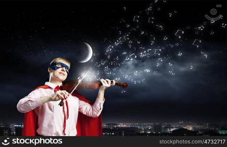 Young woman in super hero costume playing violin. She is super woman
