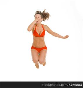 Young woman in swimsuit jumping in water