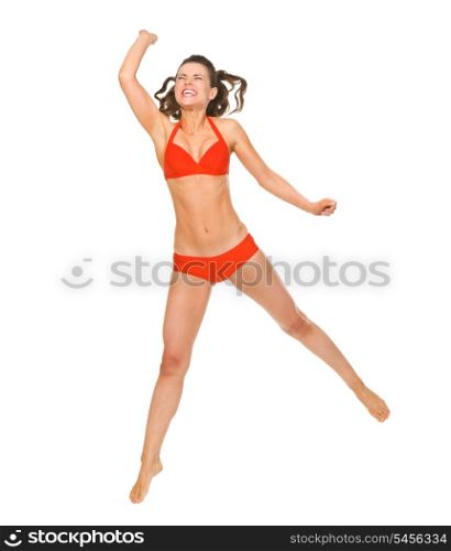 Young woman in swimsuit playing beach volleyball