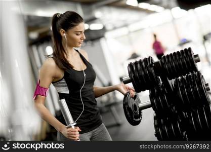 Young woman in the gym preparing for training