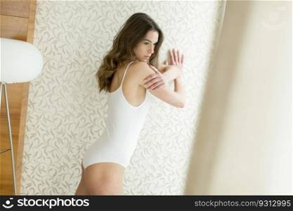 Young woman in underwear in the room