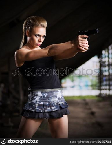 Young woman in uniform with gun (dark version)
